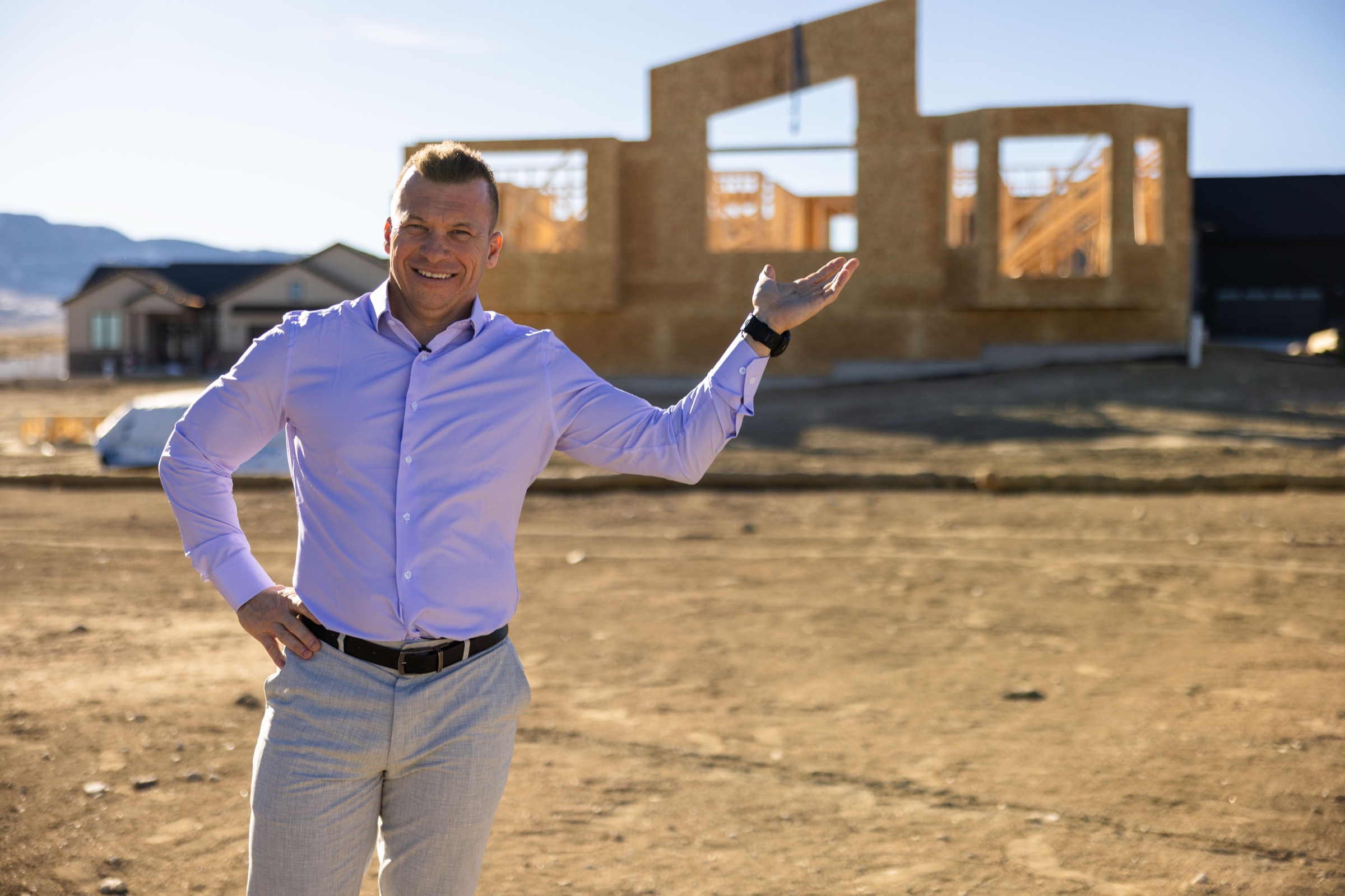 Jason Lewis standing at a residential construction site