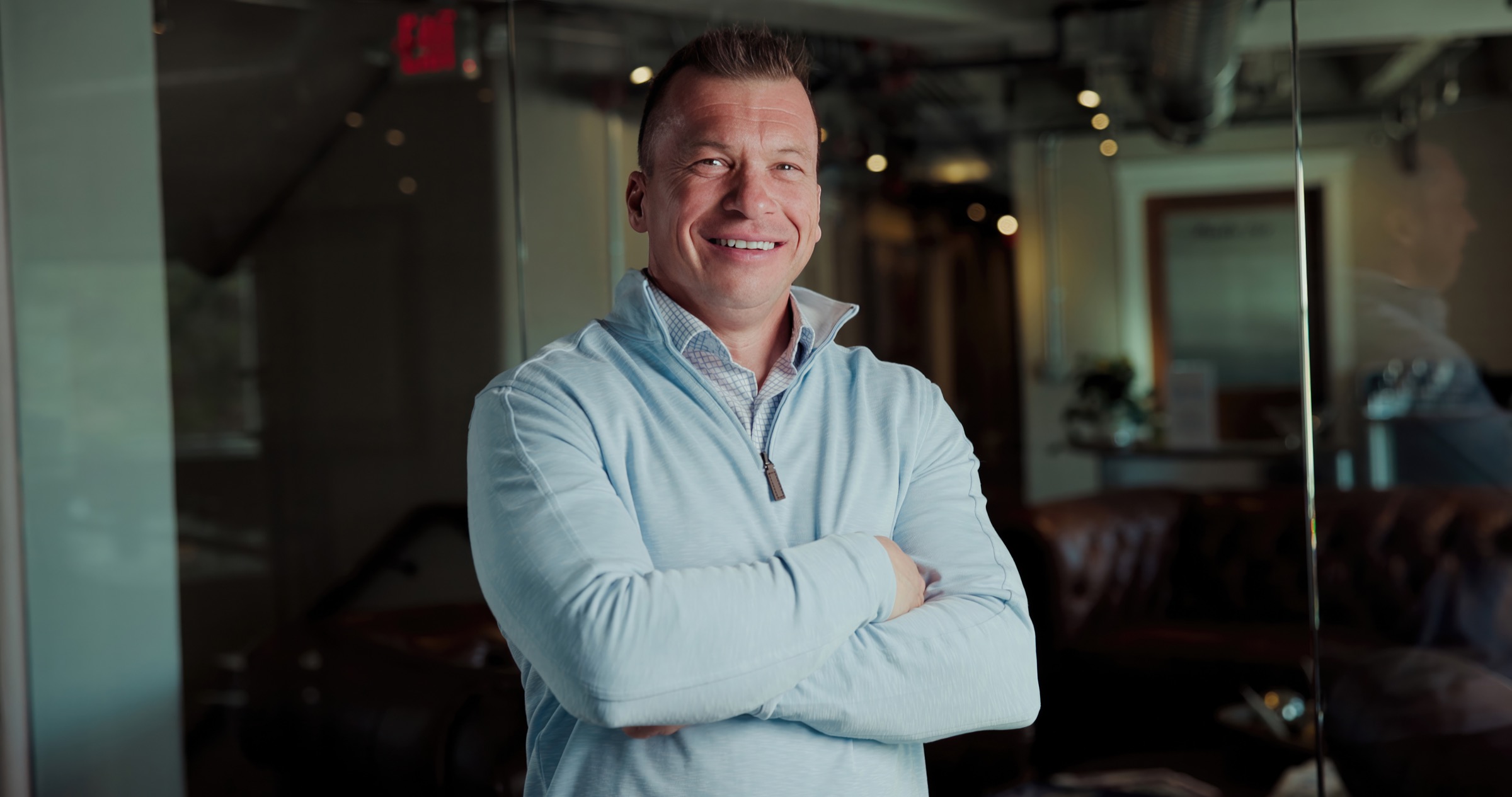 Close portrait of Jason Lewis through reflective glass